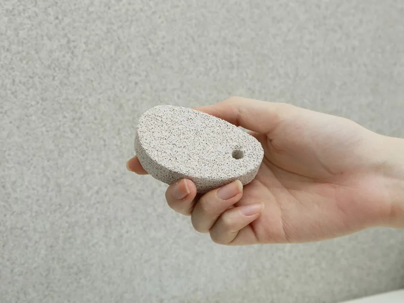 A hand holding a pumice stone