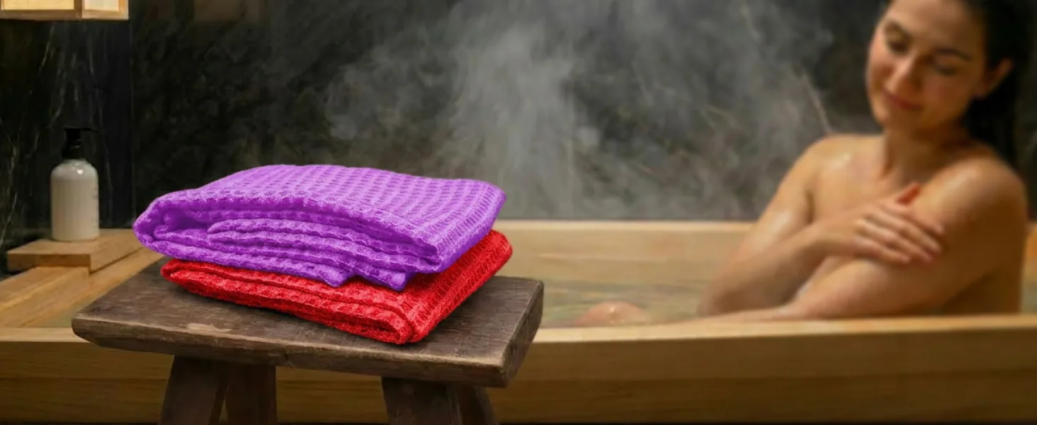 Body towels on a wooden stool beside a Japanese bath