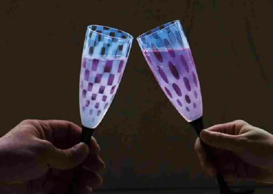 Two Hirota Glass champagne flutes with an opal pattern
