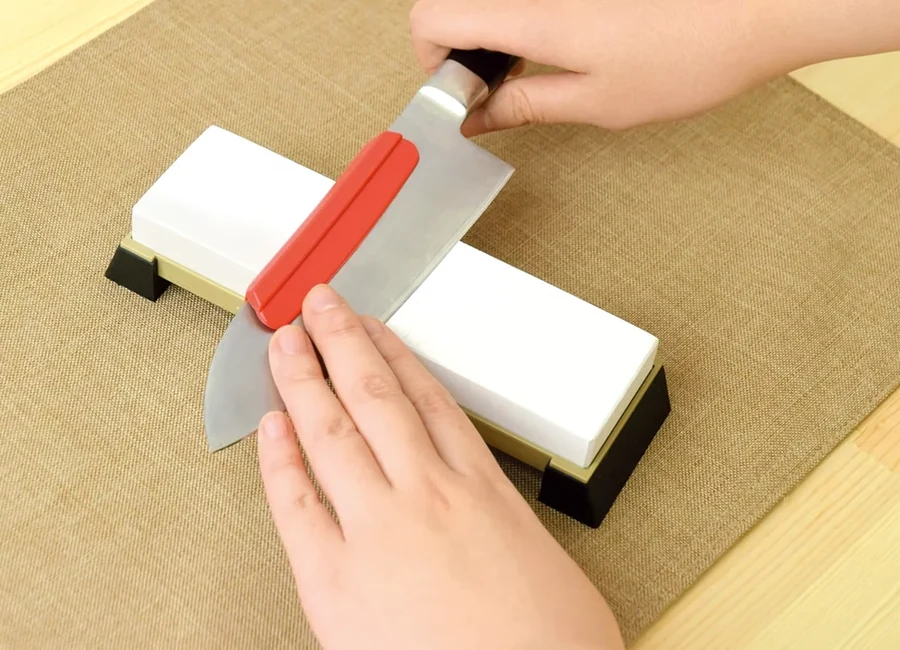 Wabi Sabi WARE knife sharpening holder clipped to a knife on a whetstone