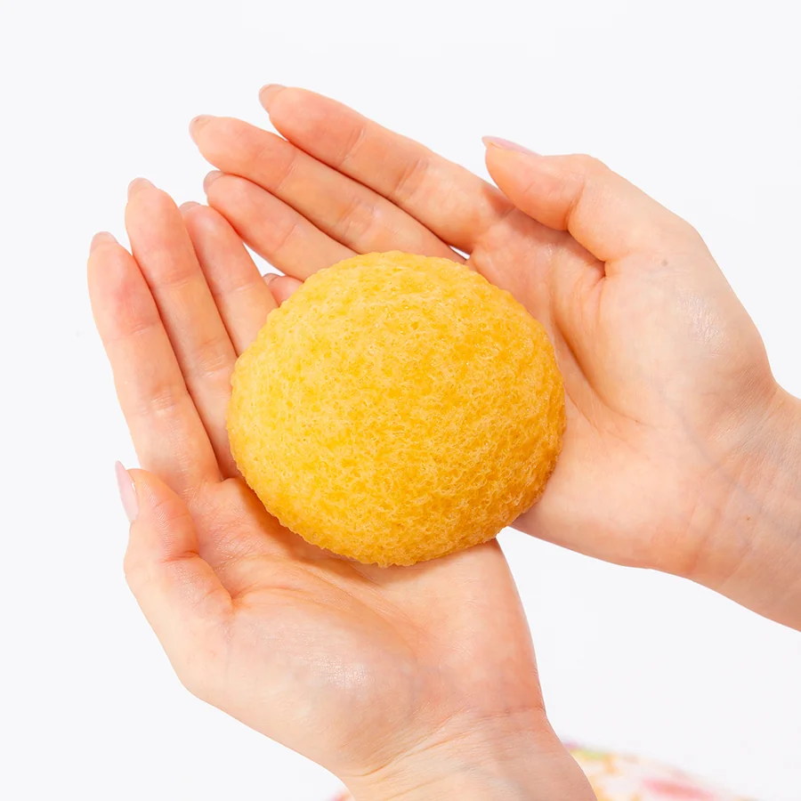 Yuzu konjac face sponge held in two hands