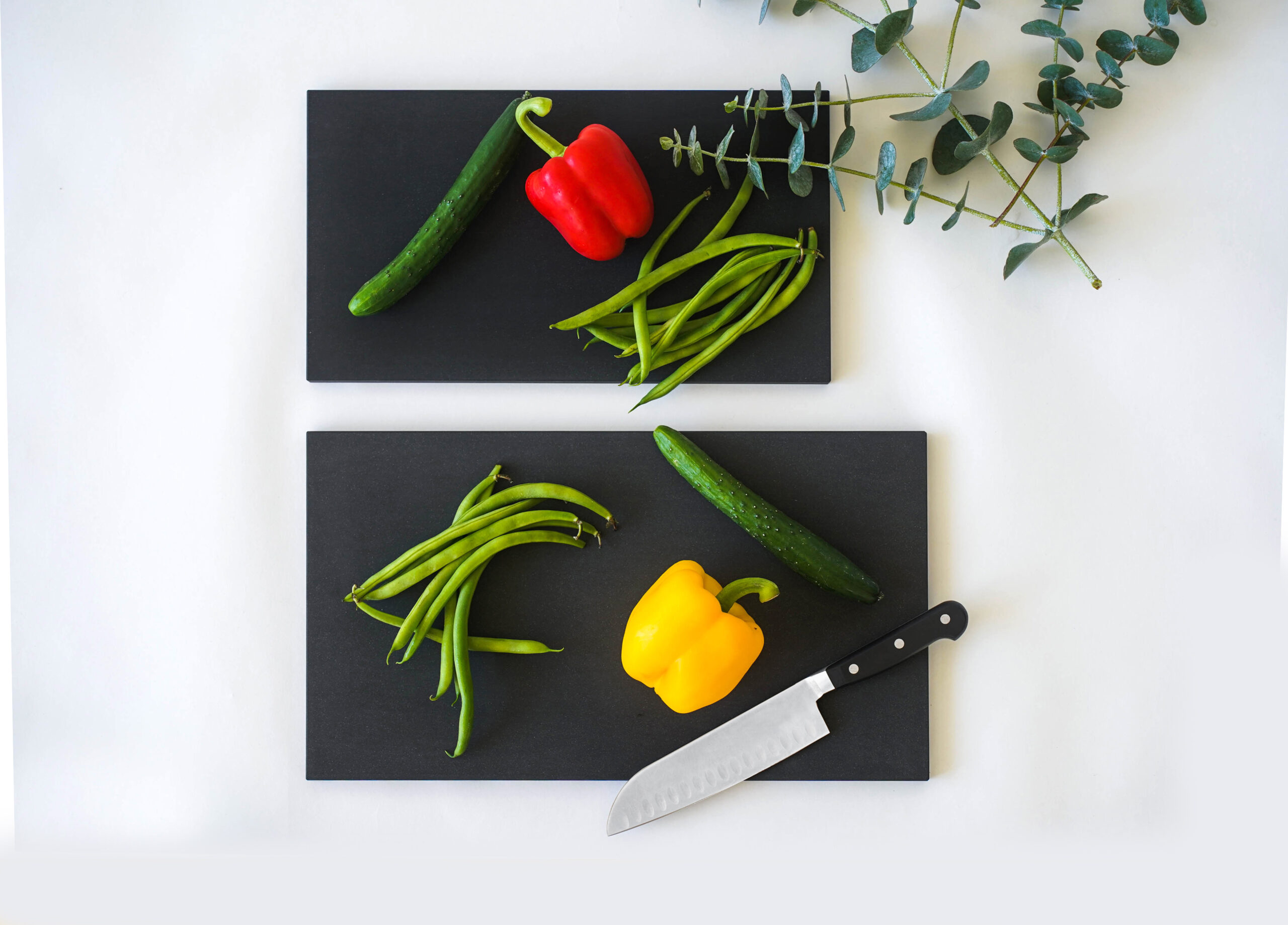 Fresh vegetables on two matte black RUBBER Raba Premium cutting boards