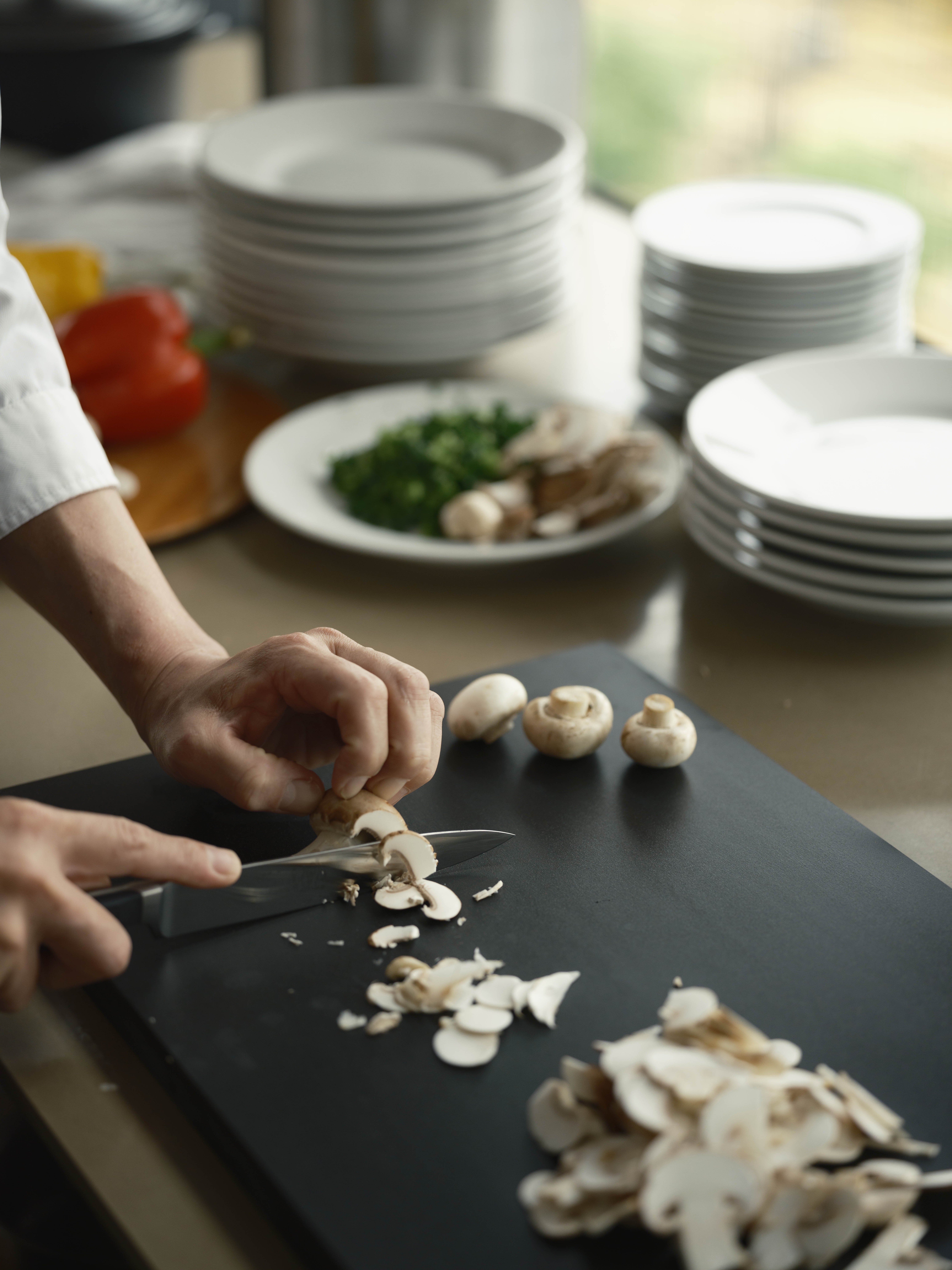 Preparing mushrooms on a black RUBBER Raba Premium cutting board